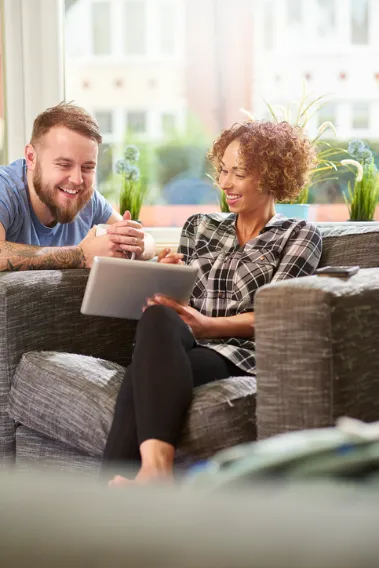 Couple looking at online banking on their tablet