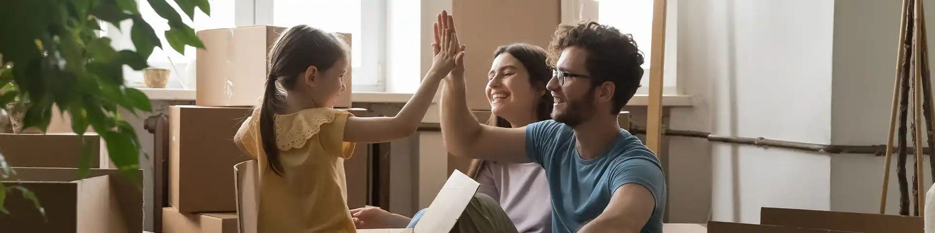 child and parents starting to unpack from their new home