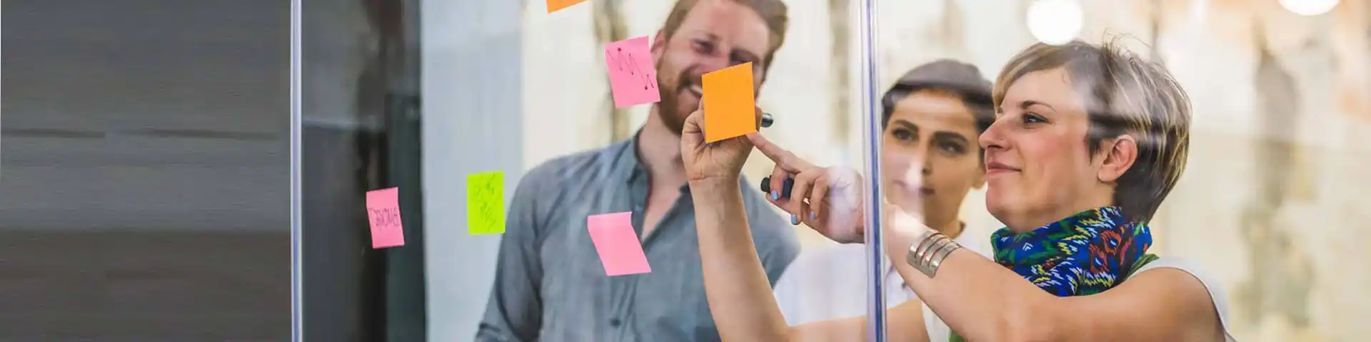 office meeting with sticky notes on a glass wall