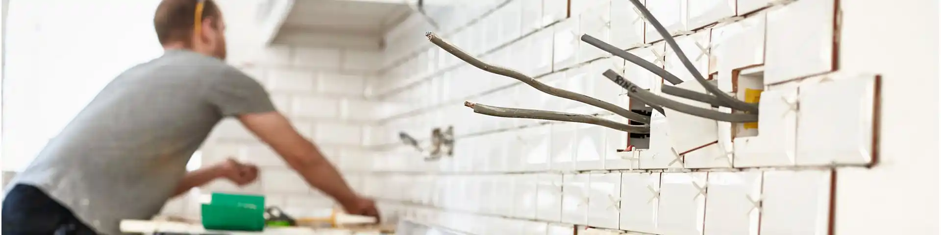 electrician working on a home with exposed wires