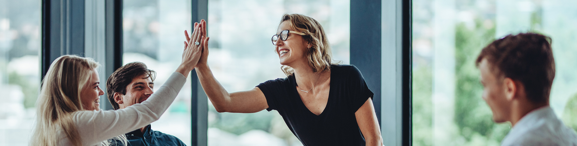 Employees high-fiving each other