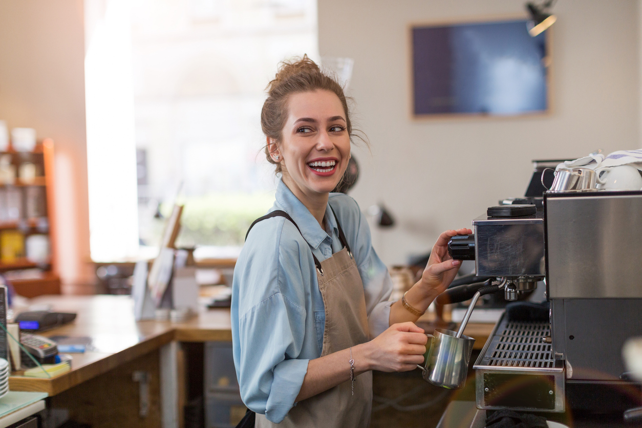 woman laughing making coffee