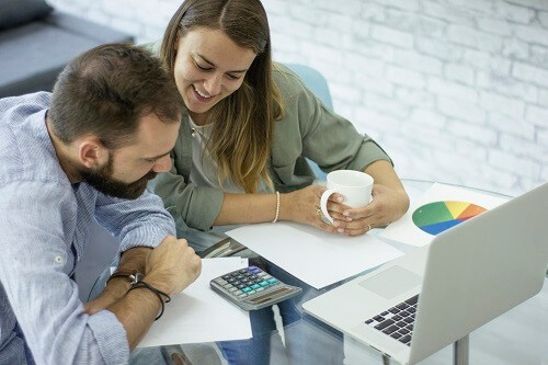 ManAndWomanReviewingCalculator