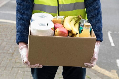 ManCarryingFoodDonations