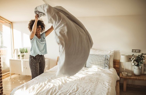 WomanMakingBed